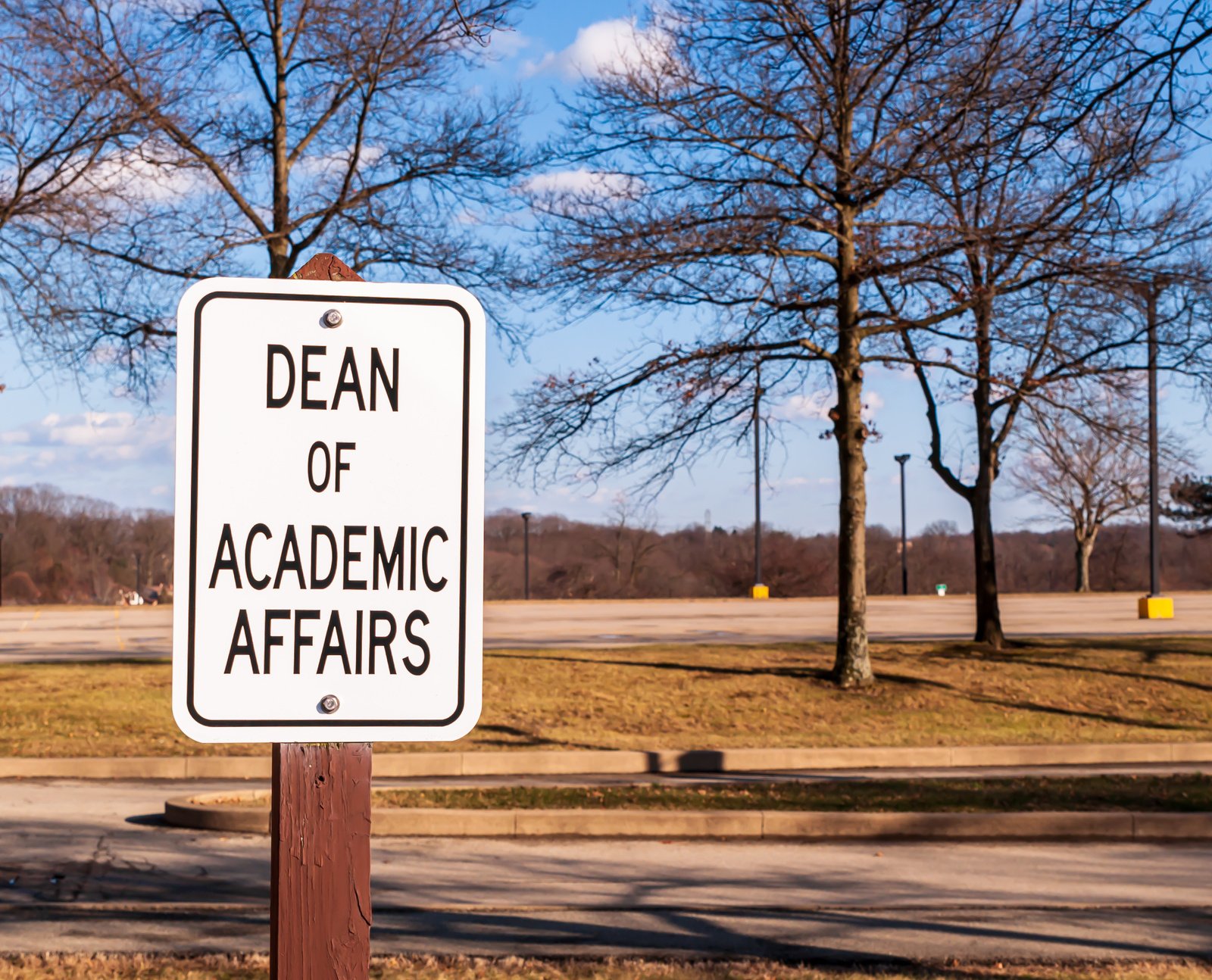 Dean of Academic Affairs sign outside in a parking lot